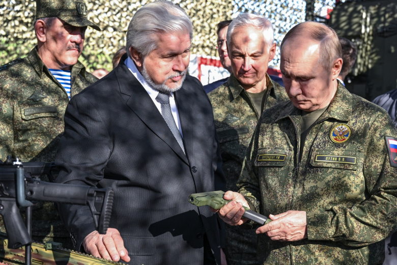 Владимир Путин и министр обороны РФ Андрей Белоусов (справа налево) во время осмотра вооружения, военной и специальной техники на территории военного полигона Мулино