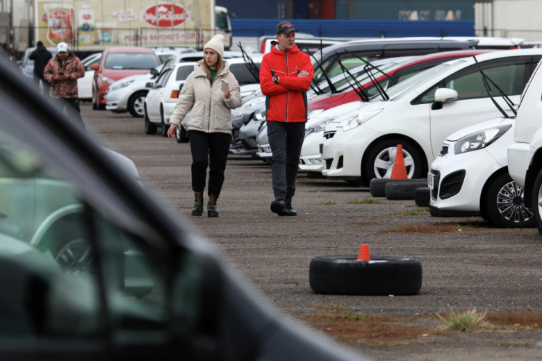 Посетители возле подержанных праворульных автомобилей производства Японии на крупнейшем в городе авторынке «777» в Красноярске