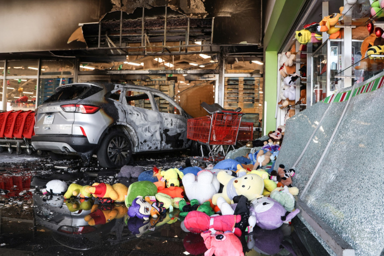 Сгоревший автомобиль возле супермаркета в Гвадалахаре, столице штата Халиско, Мексика