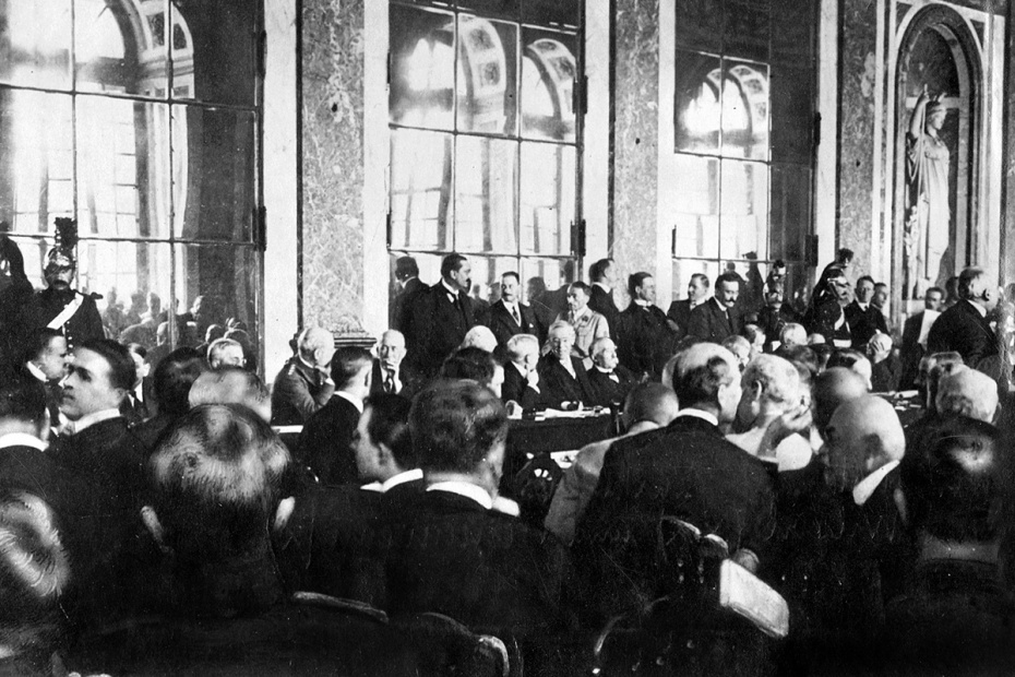 Американский президент Вудро Уилсон и французский президент Жорж Клемансо (в центре стола) подписывают Версальский договор в Зеркальном зале Версальского дворца, 1919 год