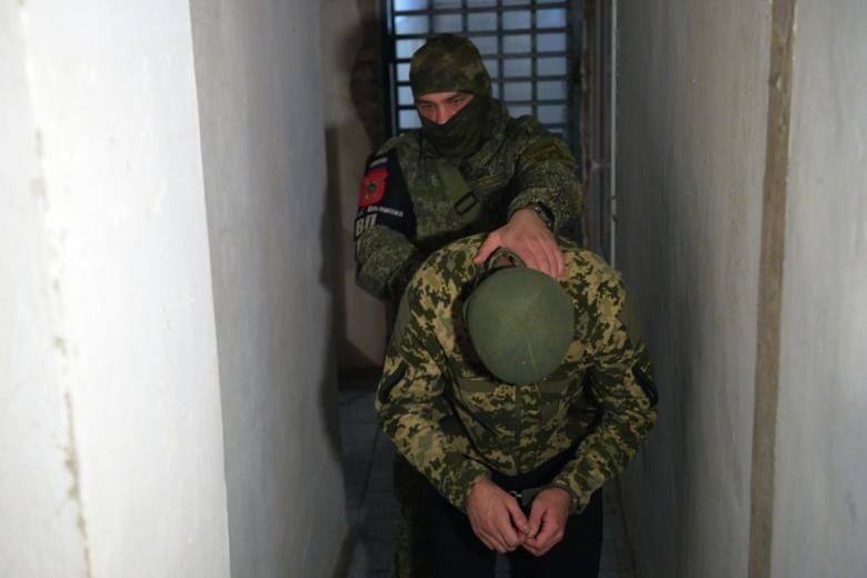 Сотрудник военной полиции и украинский военнопленный