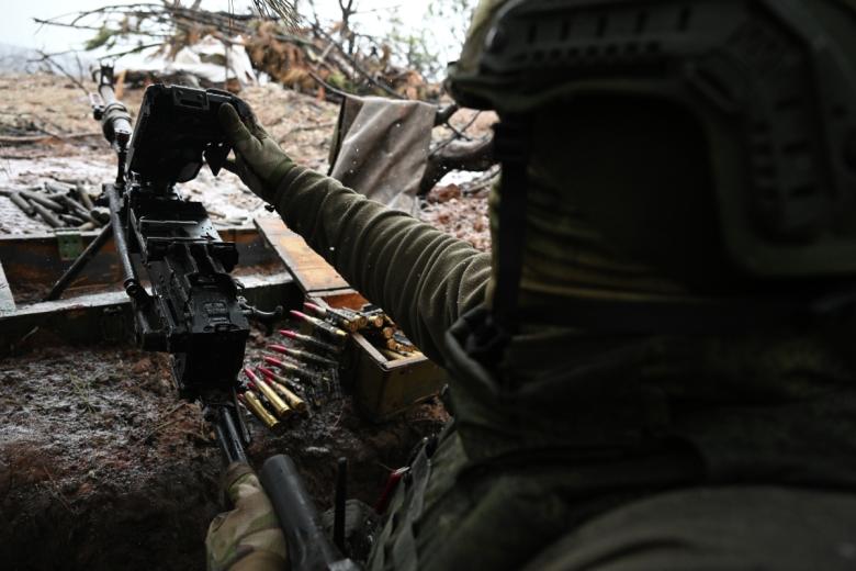 Военнослужащий ВС РФ ведет огонь по позициям ВСУ из пулемета