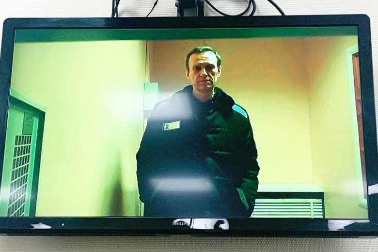 Алексей Навальный (на экране), отбывающий наказание в исправительной колонии