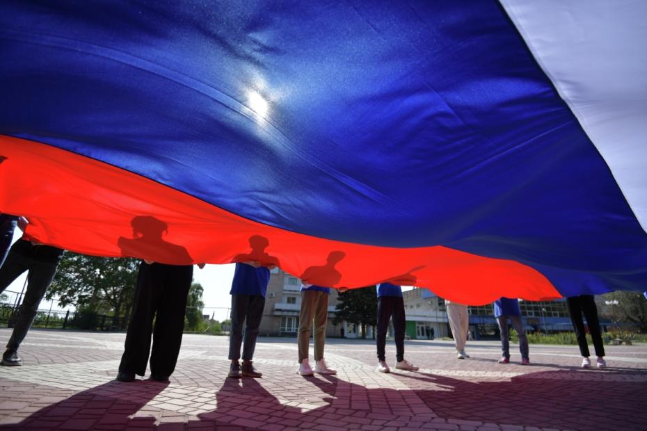 Активисты регионального отделения МГЕР развернули флаг РФ на площади Победы в Мелитополе в рамках празднования Дня воссоединения новых регионов с Россией