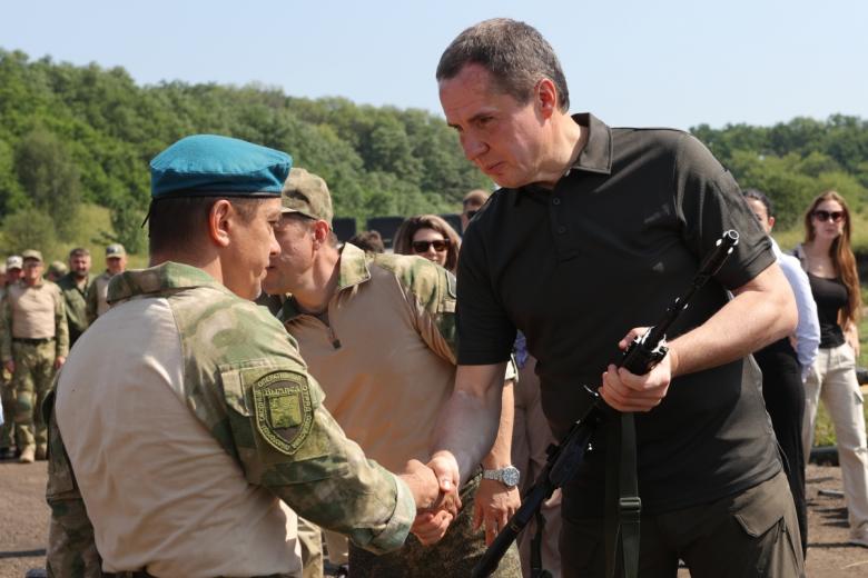 Глава Белгородской области Вячеслав Гладков (справа) выдает оружие бойцам территориальной самообороны на полигоне в Белгородской области